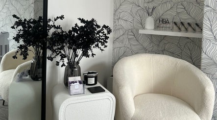 Cozy corner with chair and decor at Libby.J.Beauty, Exmouth, England, GB, showcasing serene ambiance.