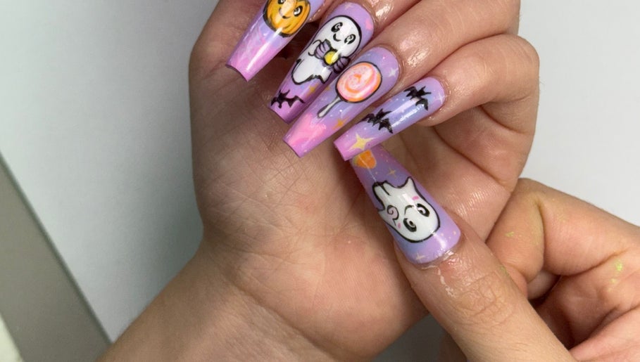 Halloween-themed nail art with ghost and pumpkin designs at NailcraftLA, Los Angeles, California, US.