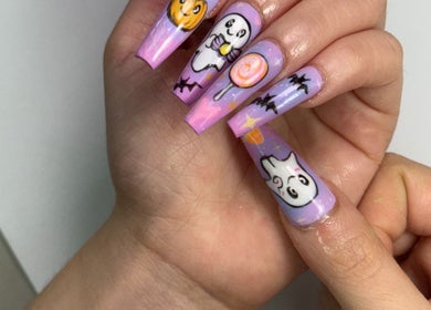 Halloween-themed nail art with ghost and pumpkin designs at NailcraftLA, Los Angeles, California, US.