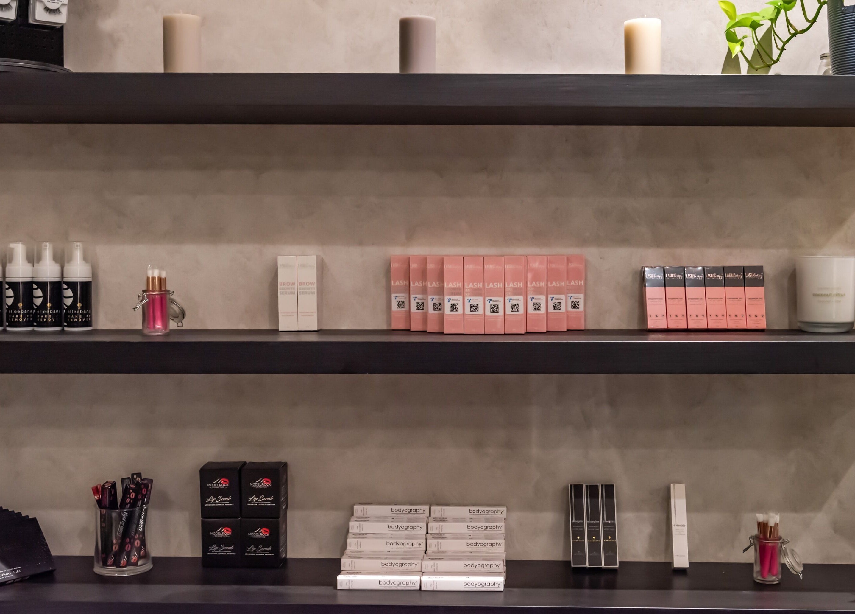 Product shelves at Nova Beauty Charlestown, Charlestown, New South Wales, AU, showcasing cosmetics and candles.