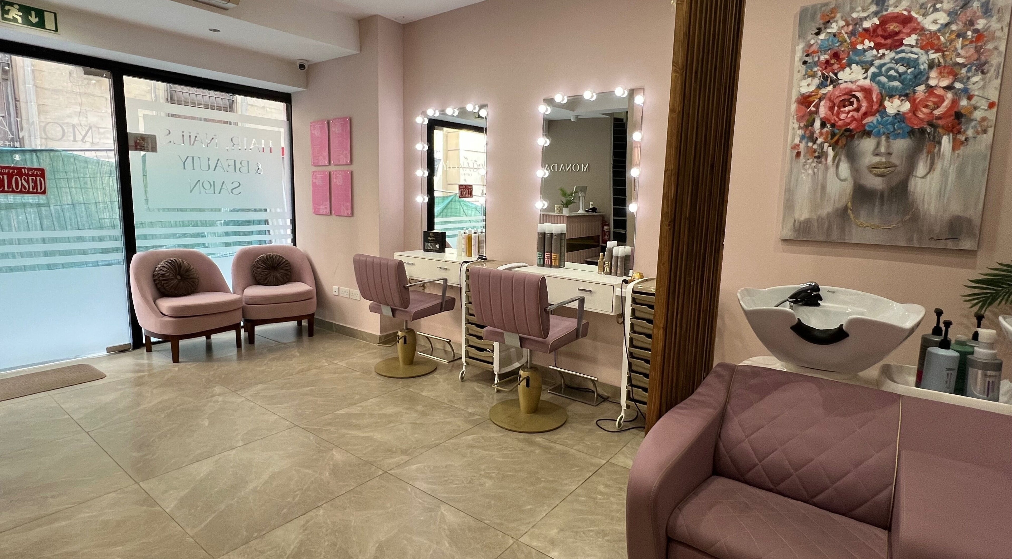 Chic and modern beauty salon interior at Monada, Il-belt Valletta, MT with stylish seating and mirrors.