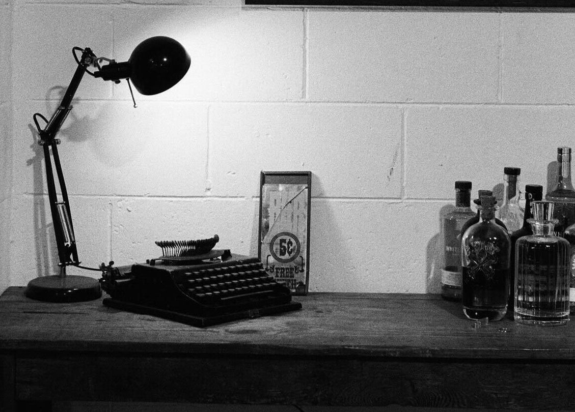 Vintage desk setup at Brookvale - Benicky and Sons, Brookvale, New South Wales, AU with typewriter and lamp.
