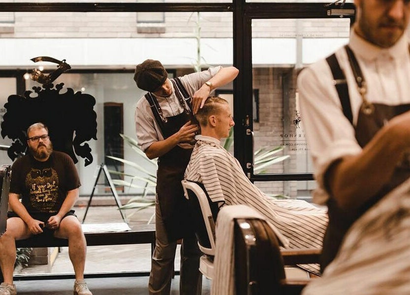 Barber styling a client's hair at Brookvale - Benicky and Sons in Brookvale, New South Wales, AU.