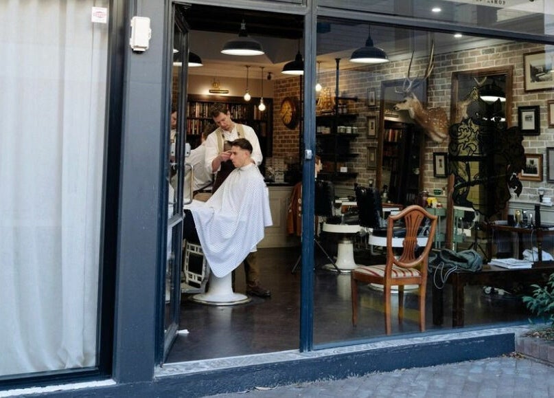 Interior of Benicky and Sons barber shop in Brookvale, New South Wales, AU showing a client getting a haircut.