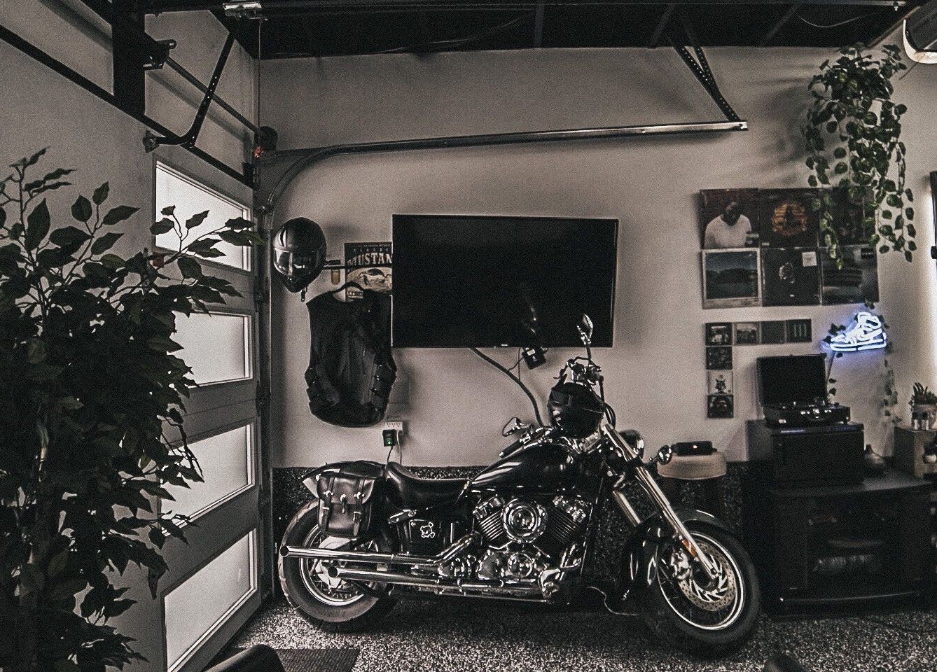 Le Studio Noir's stylish lounge with motorcycle, TV, and decor in Whitby, Ontario, CA.