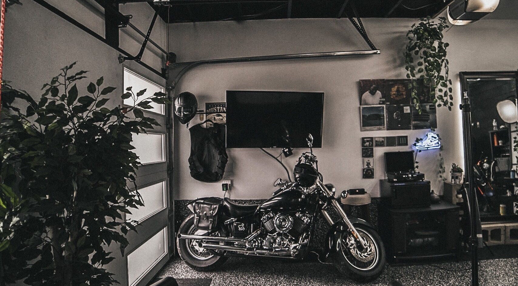 Le Studio Noir's stylish lounge with motorcycle, TV, and decor in Whitby, Ontario, CA.