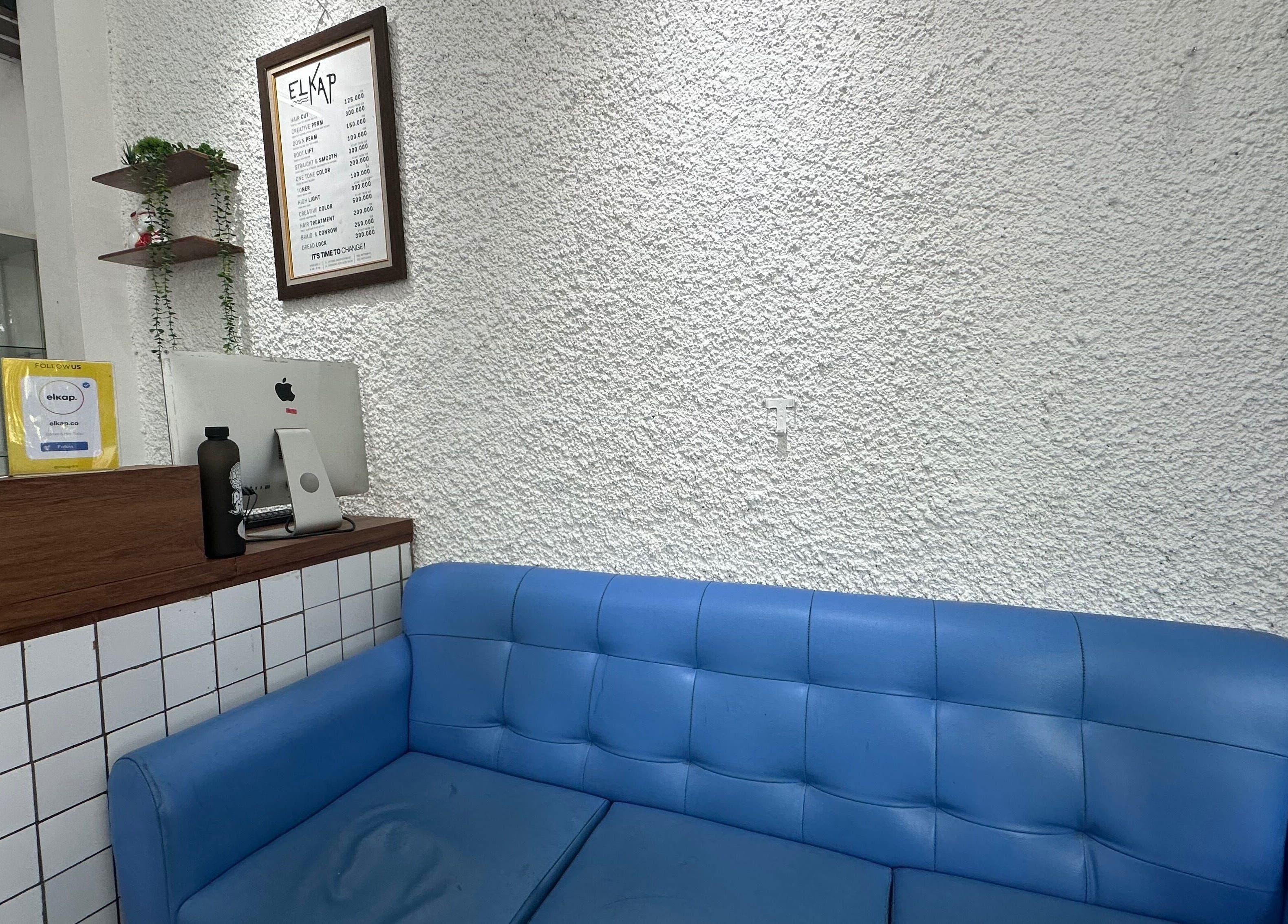 Relaxing seating area at Elkap Gading, Jawa Timur, Jawa Timur, ID with a stylish blue sofa and modern decor.