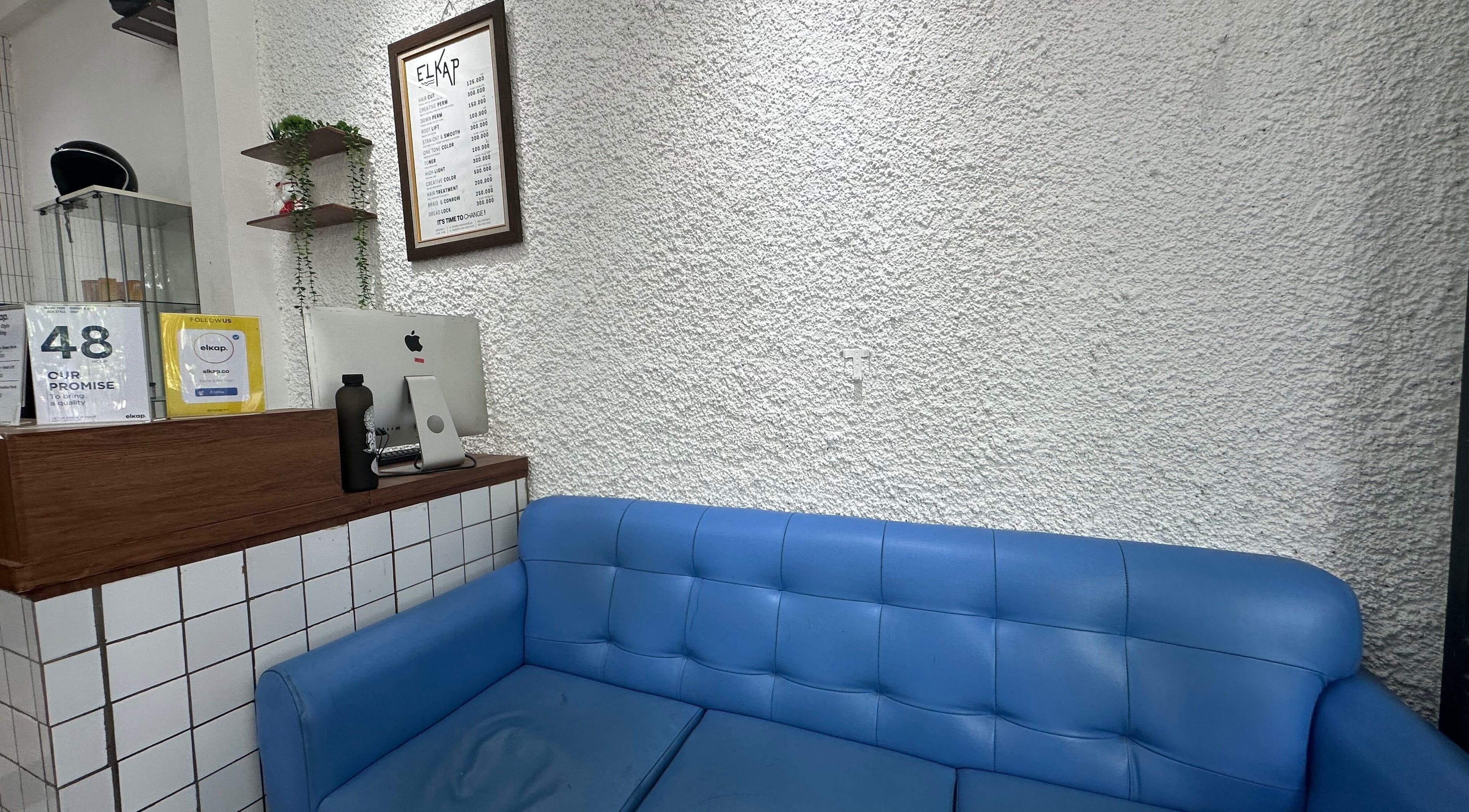 Relaxing seating area at Elkap Gading, Jawa Timur, Jawa Timur, ID with a stylish blue sofa and modern decor.