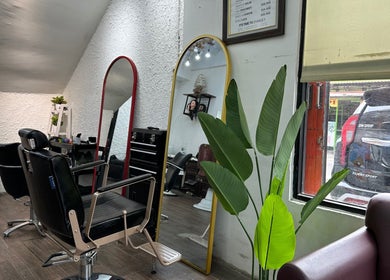 Modern salon interior at ELKAP TRUNOJOYO, Jawa Timur, Jawa Timur, ID featuring stylish mirrors and seating.