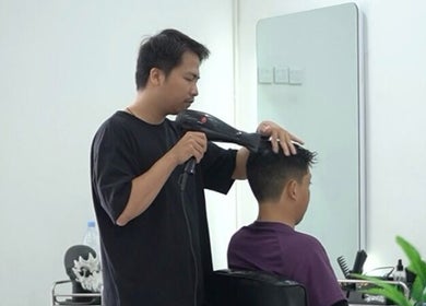 Stylist drying hair at ELKAP TRUNOJOYO salon in Jawa Timur, Jawa Timur, ID.