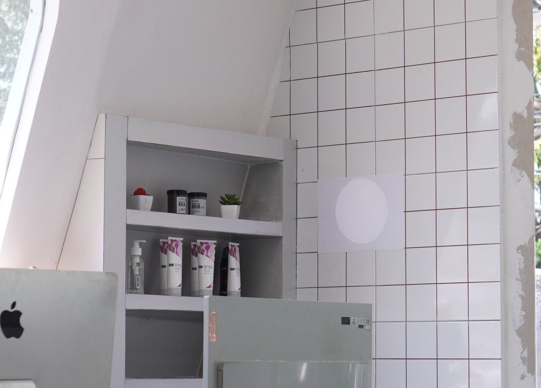 Shelf with beauty products at ELKAP TRUNOJOYO, Jawa Timur, Jawa Timur, ID. Bright, minimalist design.