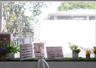 Colorful nail polish display with plants at MORI SALON, Jawa Timur, Jawa Timur, ID.