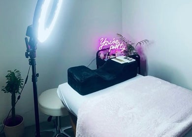 Cozy makeup station at Lumiére Makeup Artistry, South Bunbury, Western Australia, AU, highlighted by neon sign.
