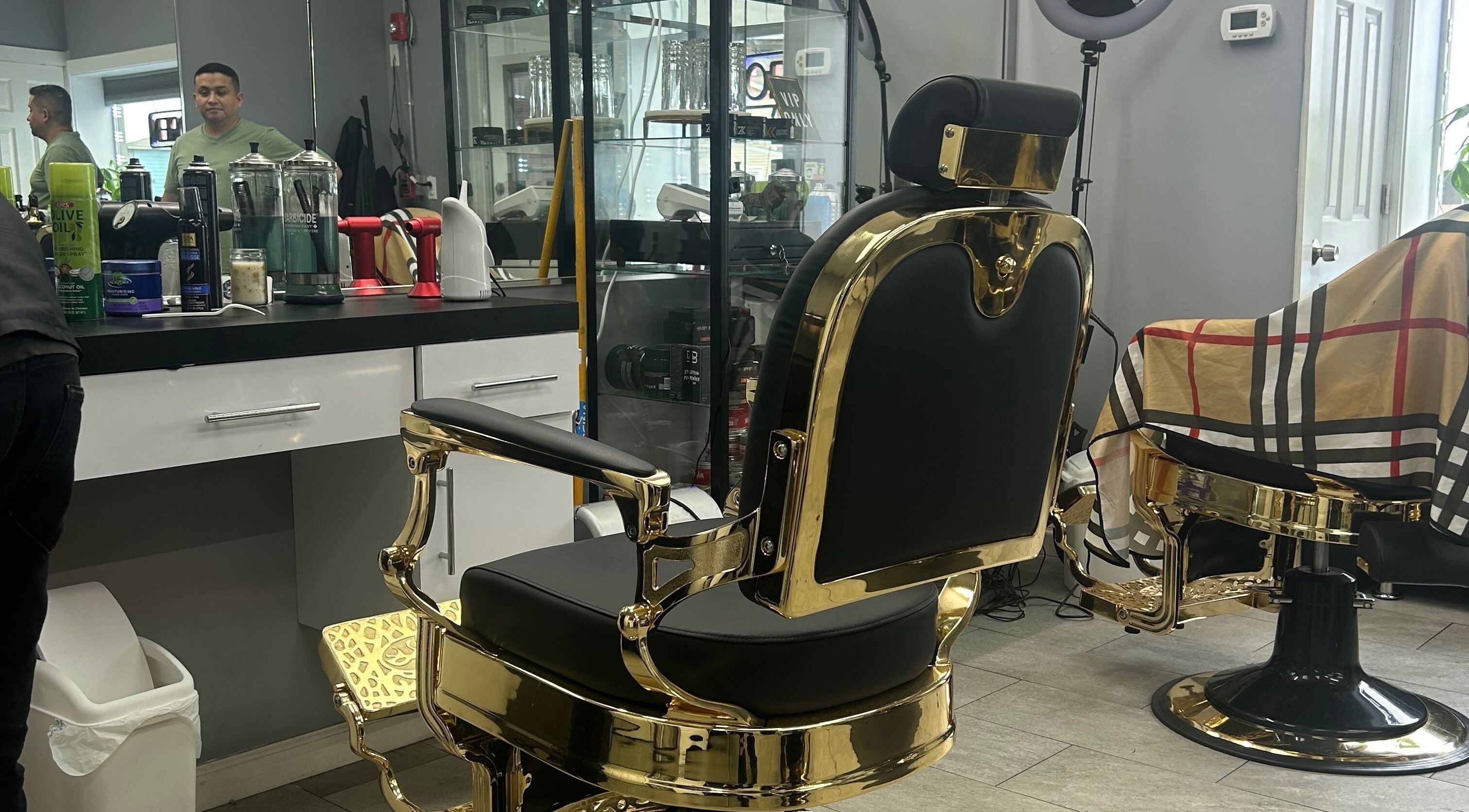 Elegant barber chair at Mildred Barber, Stamford, Connecticut, US, showcasing luxurious gold and black design.
