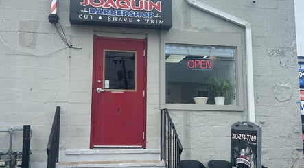 Entrance of Mildred Barber in Stamford, Connecticut, US with open sign and red door.