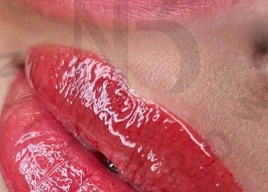 Close-up of glossy red lips featured at Nila Brows, Melbourne, Victoria, AU, showcasing expert lip care.