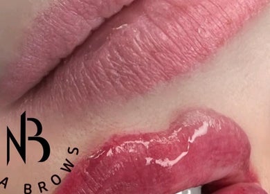 Close-up of glossy lips with Nila Brows logo, highlighting beauty services in Melbourne, Victoria, AU.