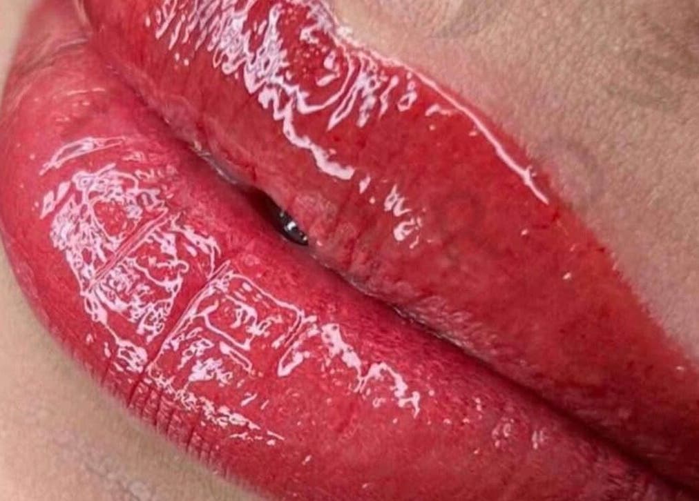 Close-up of glossy red lips at Nila Brows, Melbourne, Victoria, AU.