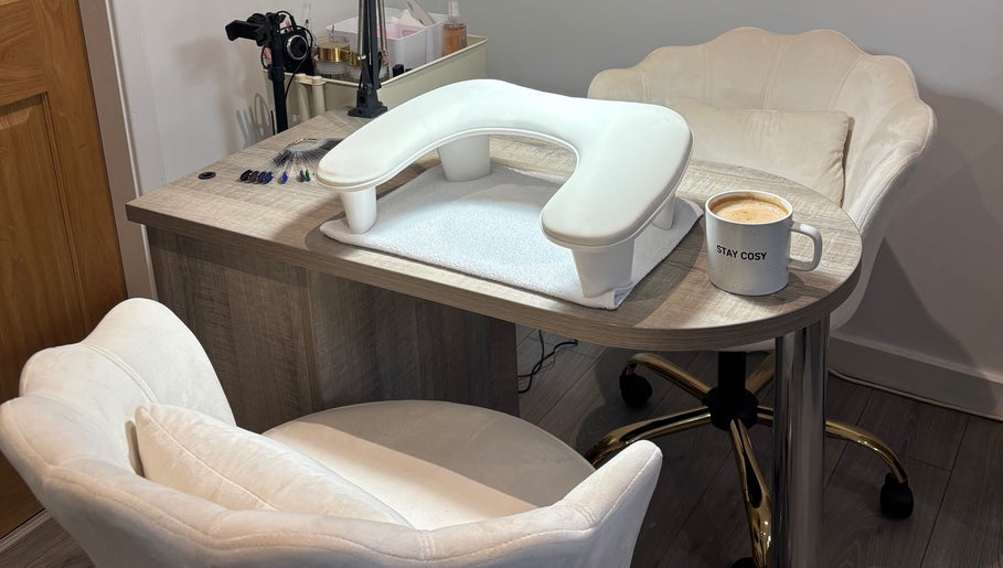 Comfortable nail station at Nova Nails & Beauty, Handforth, England, GB with a cozy mug on the table.