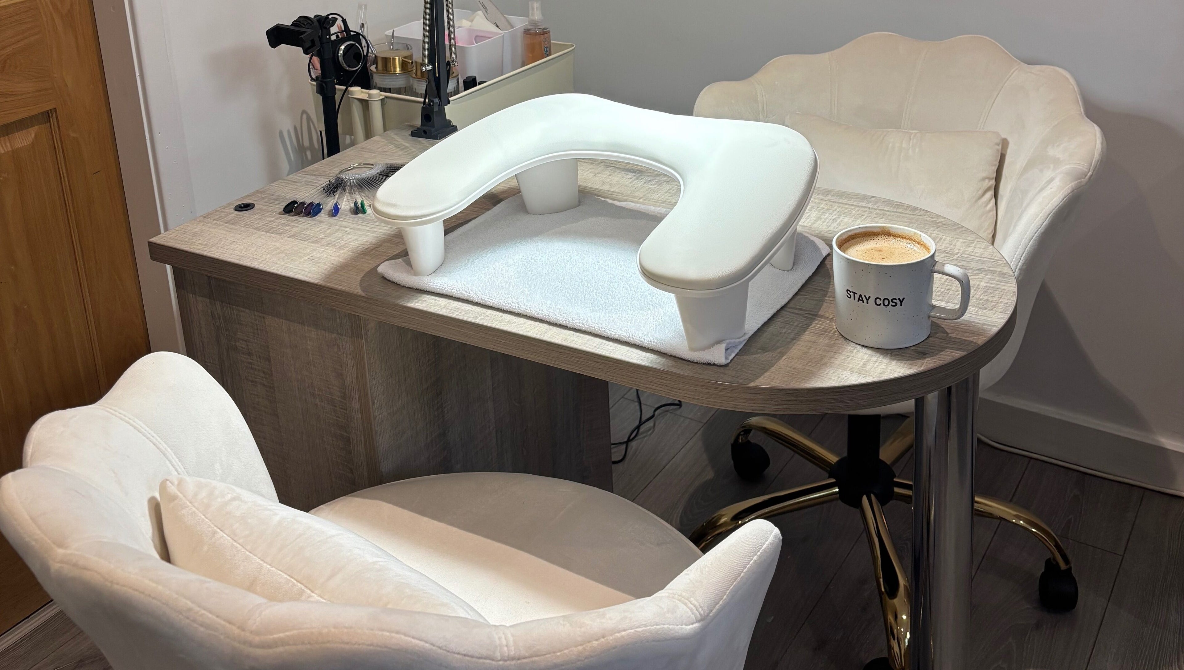 Inviting nail station at Nova Nails & Beauty in Handforth, England, GB with comfy chairs and a cozy coffee mug.