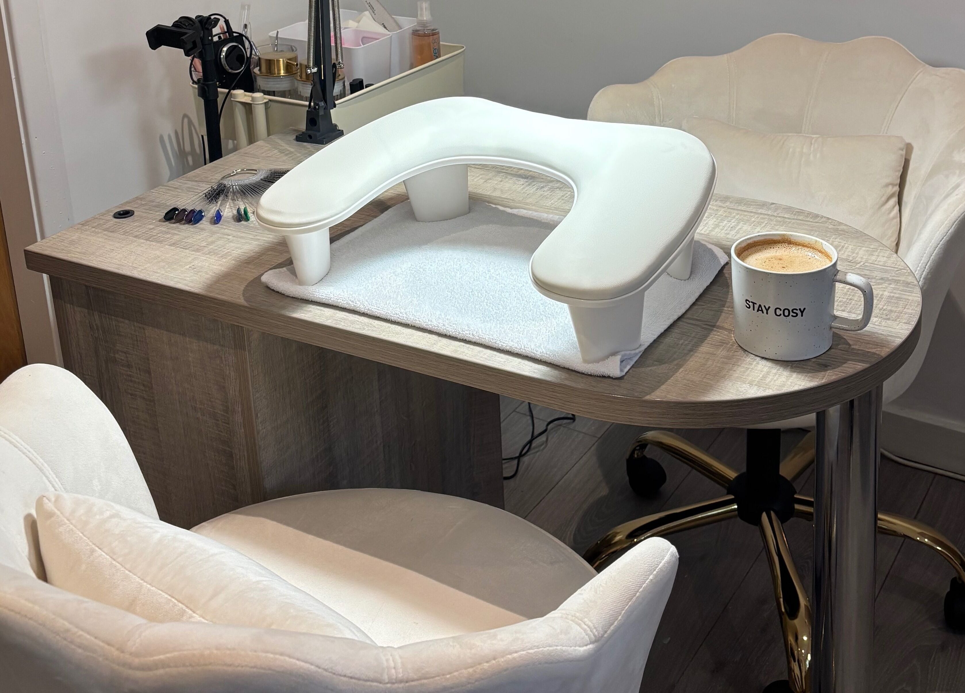 Inviting nail station at Nova Nails & Beauty in Handforth, England, GB with comfy chairs and a cozy coffee mug.