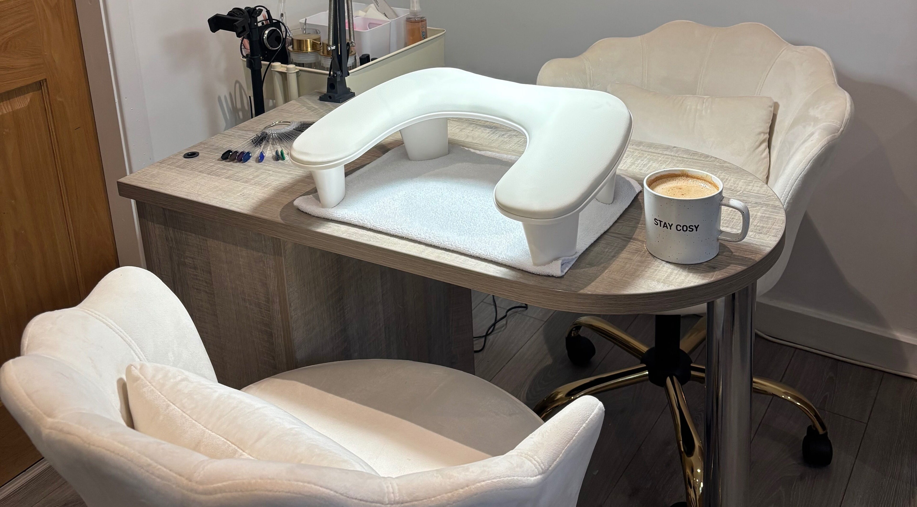 Inviting nail station at Nova Nails & Beauty in Handforth, England, GB with comfy chairs and a cozy coffee mug.