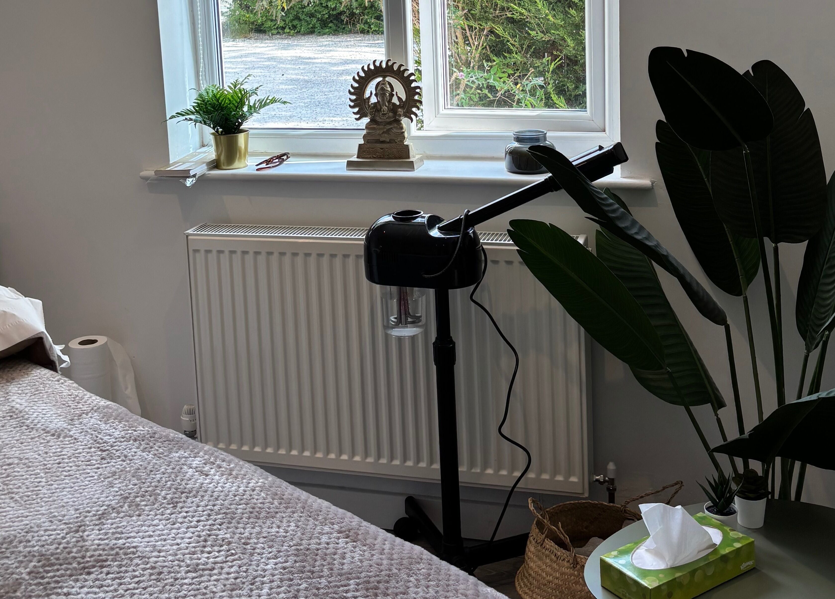 Nova Nails & Beauty in Handforth, England, showcases a tranquil treatment room with lush plants and soft linens.