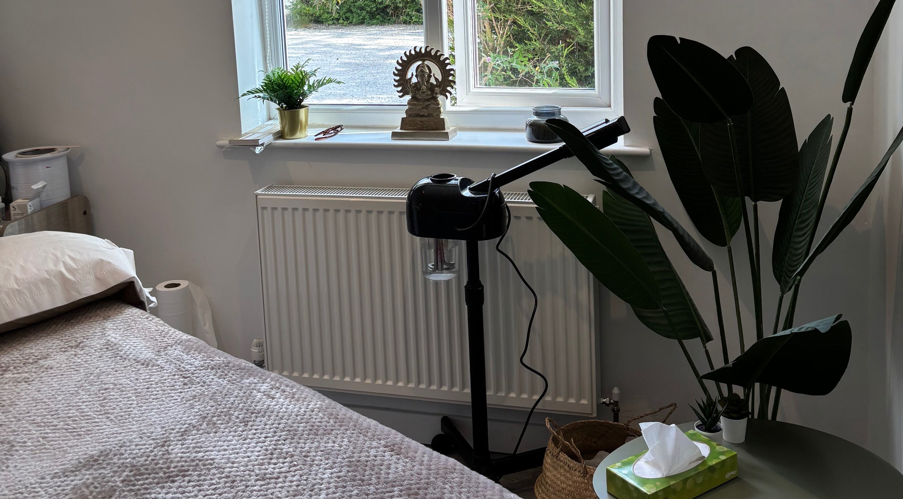 Nova Nails & Beauty in Handforth, England, showcases a tranquil treatment room with lush plants and soft linens.