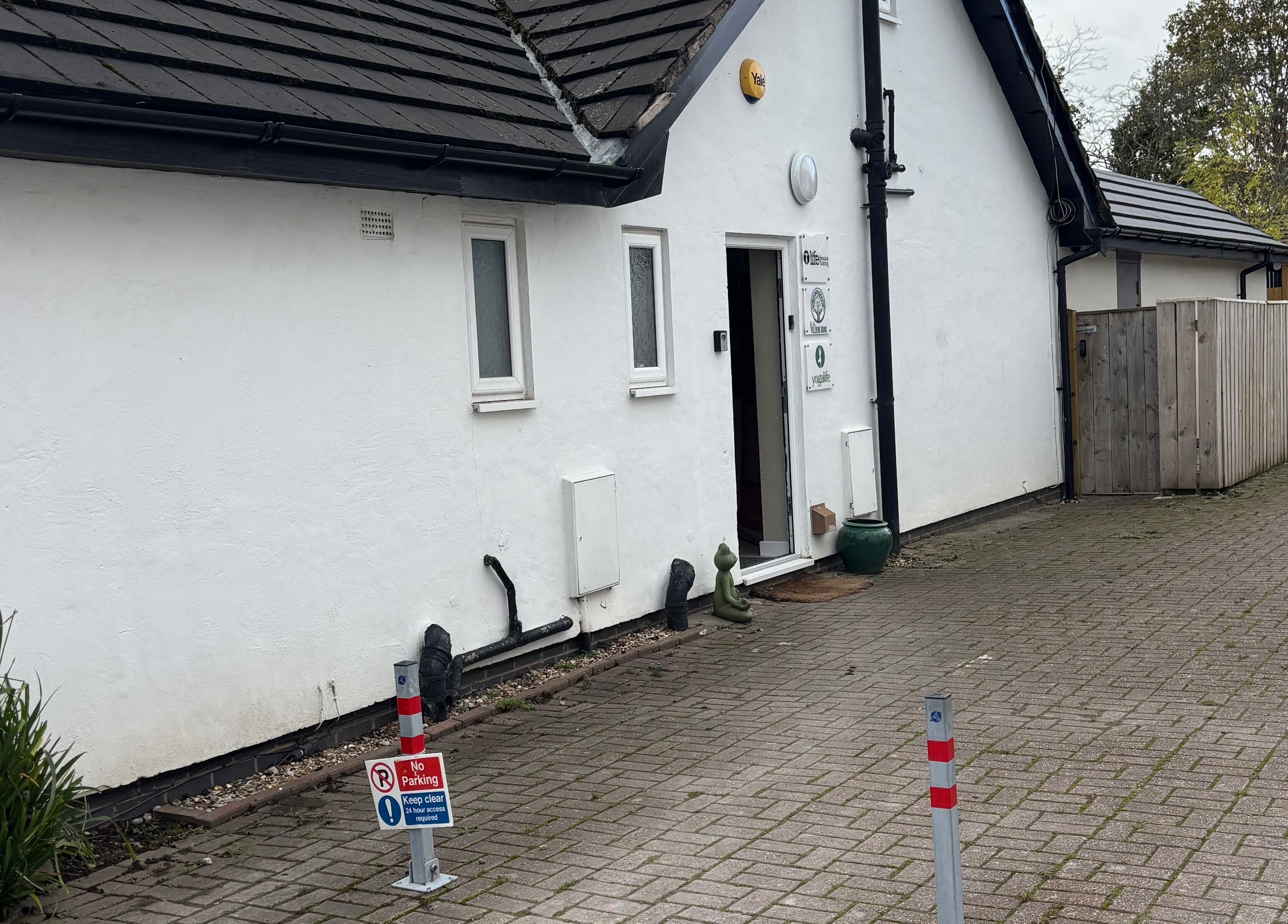 Entrance to Nova Nails & Beauty in Handforth, England, features a welcoming path and stylish décor.