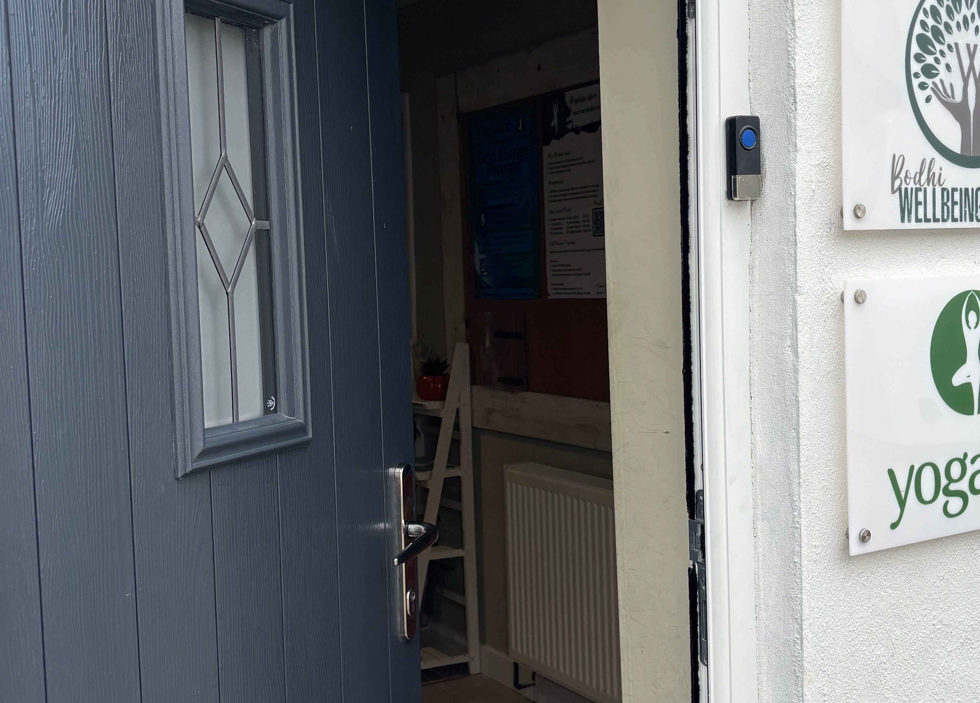 Open door showing signs for bodhi wellbeing rooms and yogalife near Nova Nails & Beauty, Handforth, England, GB.