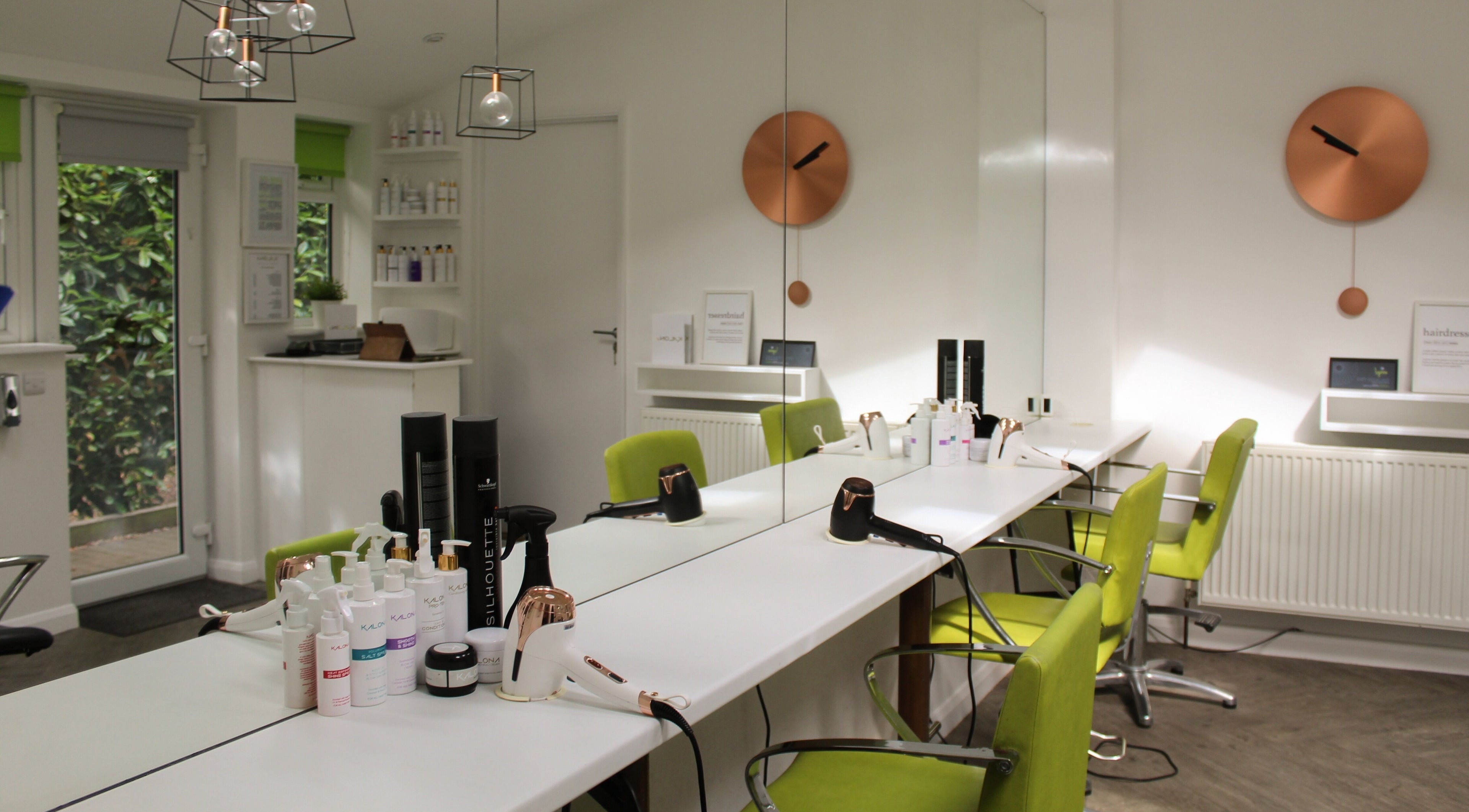 Modern hair salon interior at Lynne Hair Stylist, Ipswich, England, GB with sleek design and vibrant green chairs.