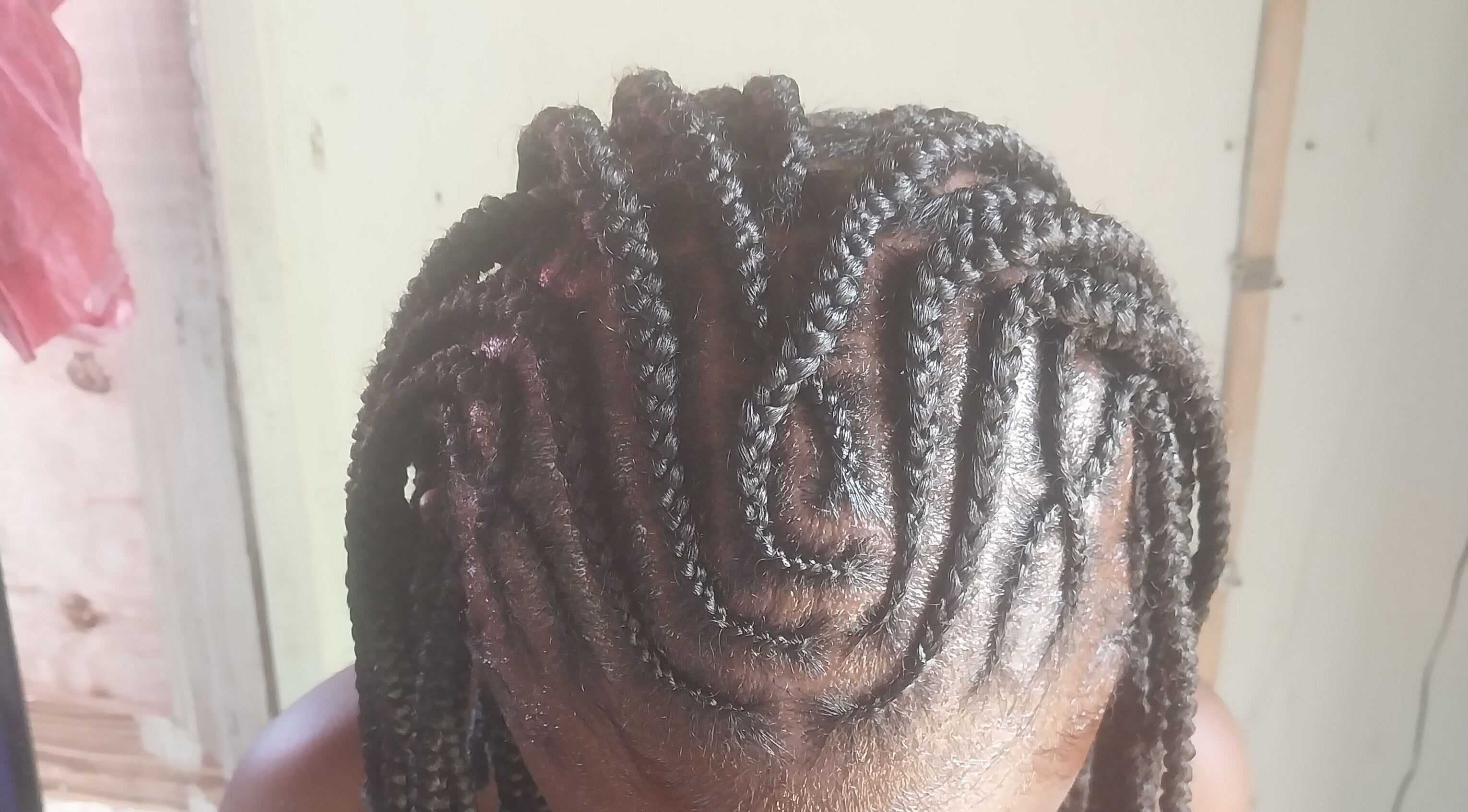 Intricate cornrow braiding at Braidsby.Merrika in Bridgetown, Saint George, BB.