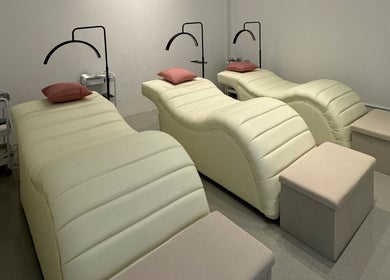 Tranquil treatment room at Moonlash Studio Tukad Barito in Bali, Bali, ID, featuring plush loungers for relaxation.