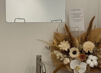 Floral arrangement with mirror and card at Moonlash Studio Tukad Barito, Bali, Bali, ID.