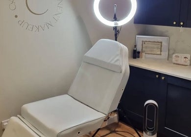 Modern treatment room at Cambridge Permanent MakeUp, Warboys, England, GB with a beauty chair and ring light.
