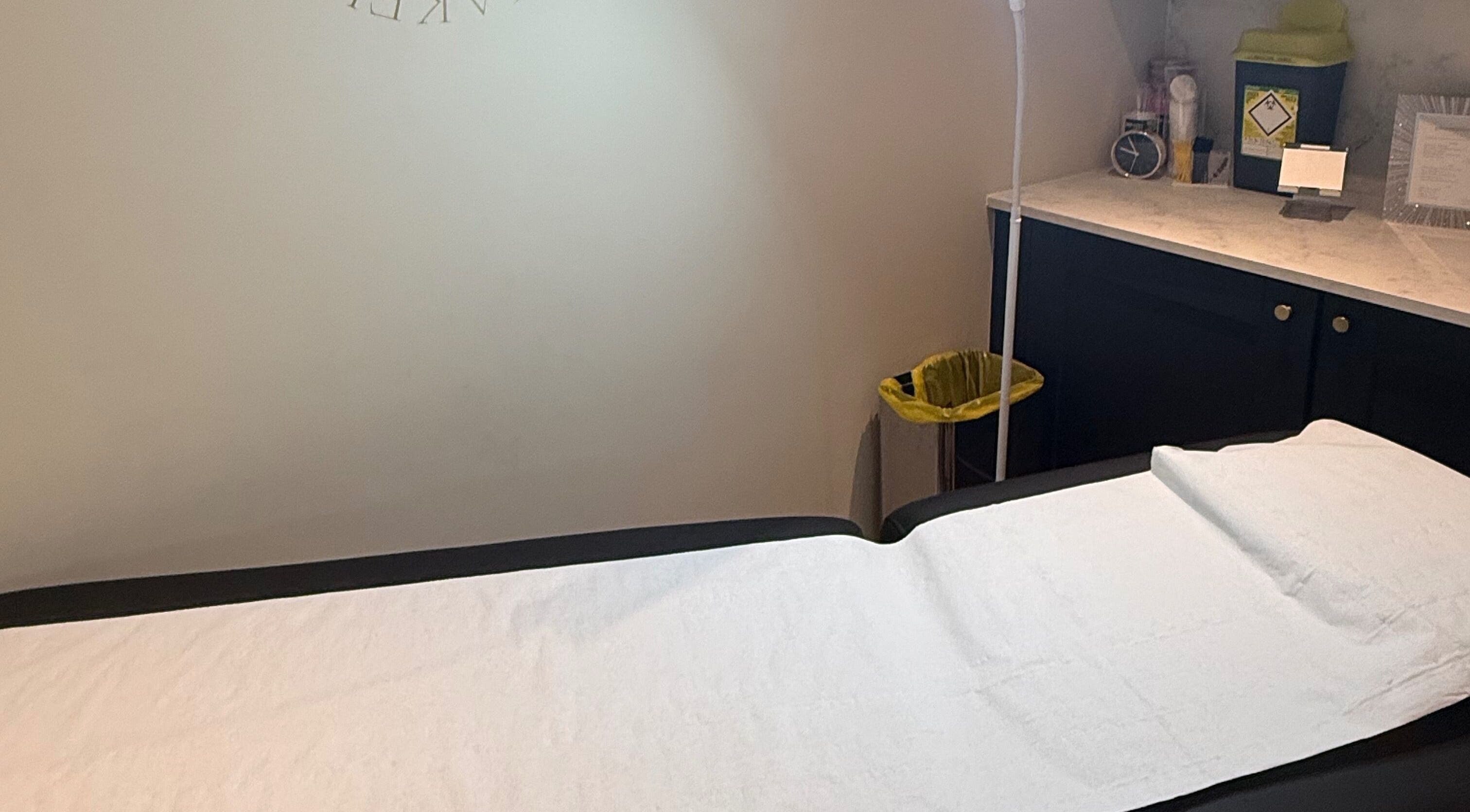 Calm treatment room at Cambridge Permanent MakeUp, Warboys, England, GB with a prepared bed.