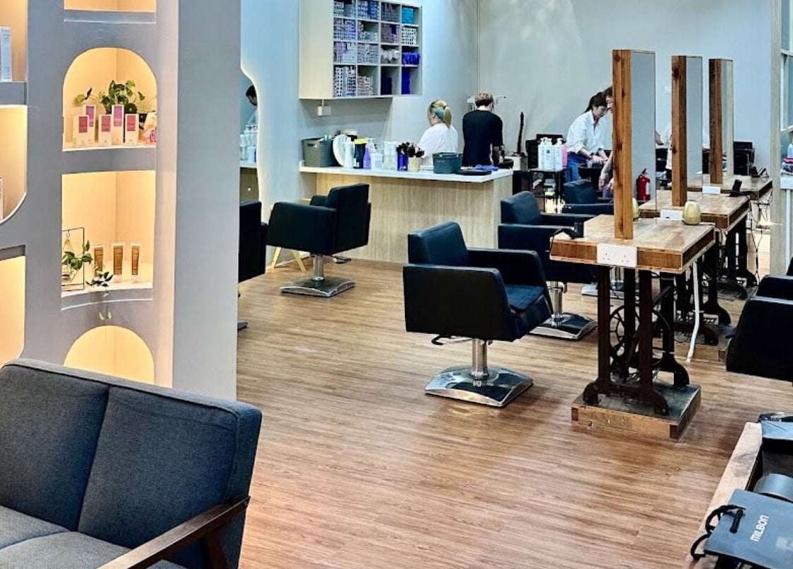 Modern interior of Elements Hair Salon in Cheras, Selangor, MY, featuring stylish seating and product displays.
