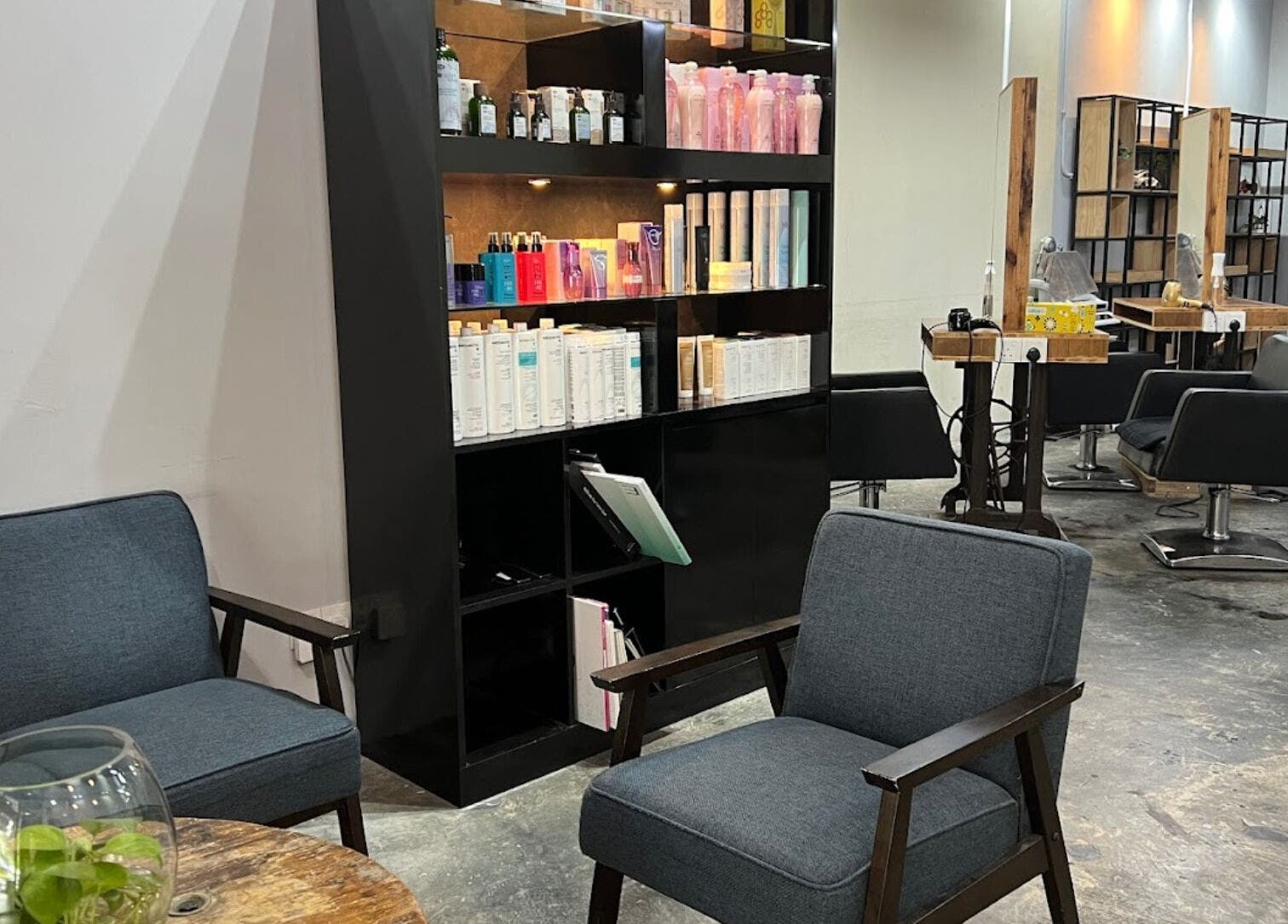 Interior of Elements Hair Salon in Cheras, Selangor, MY, featuring modern seating and product displays.