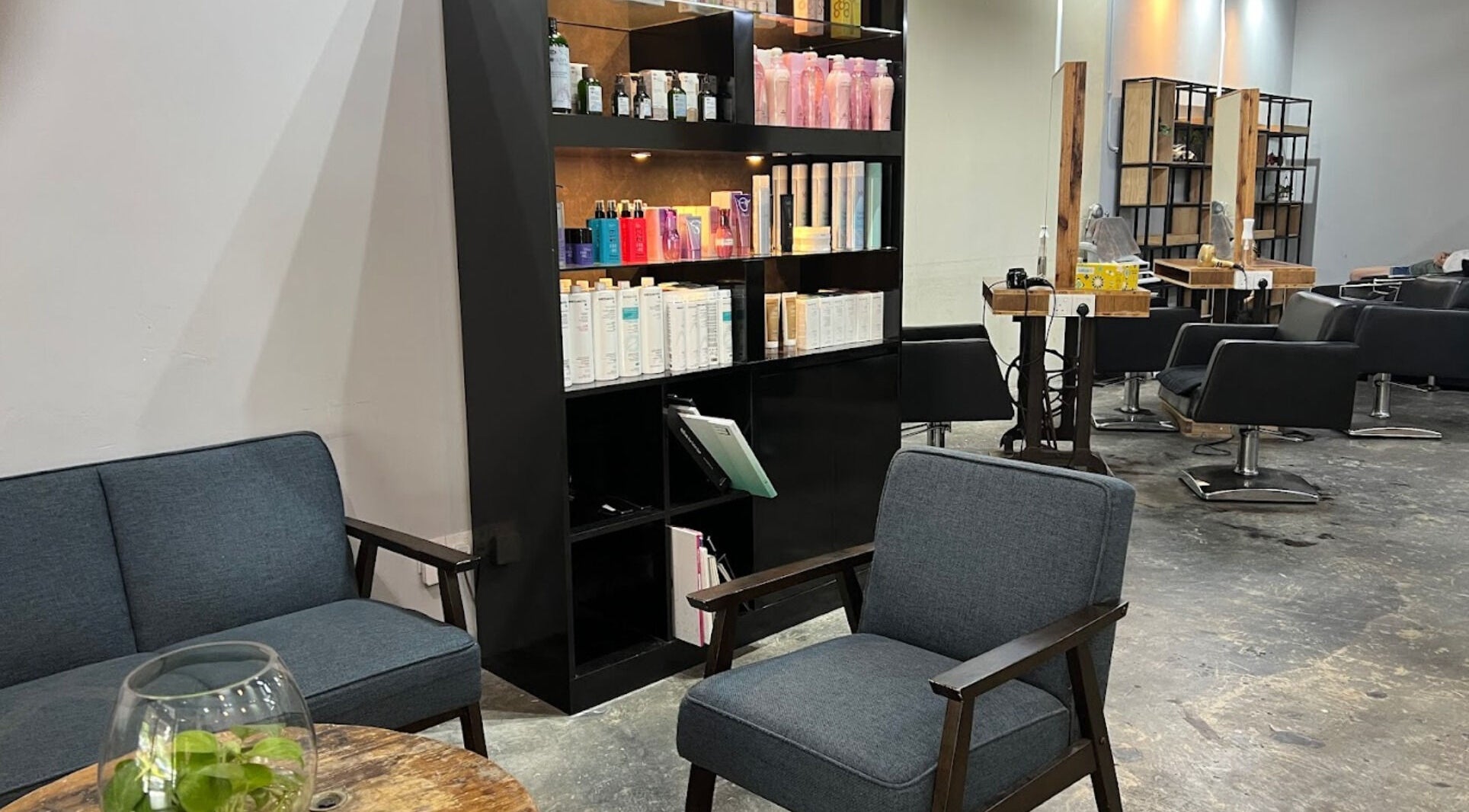 Interior of Elements Hair Salon in Cheras, Selangor, MY, featuring modern seating and product displays.
