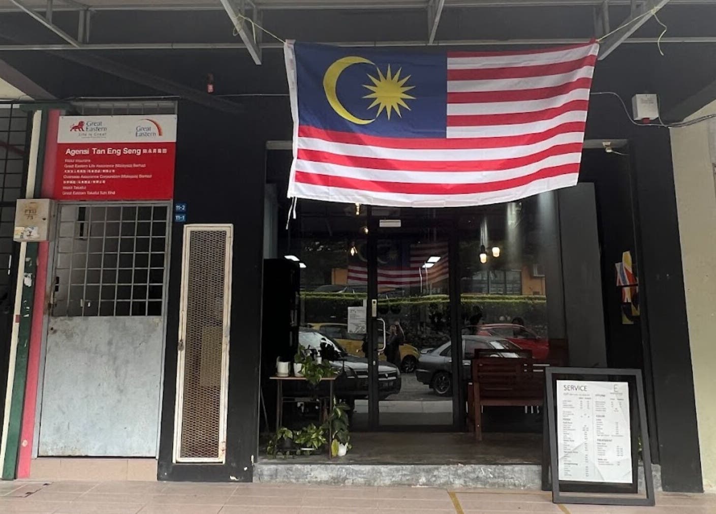Entrance of Elements Hair Salon in Cheras, Selangor, MY, featuring potted plants and Malaysia flag.