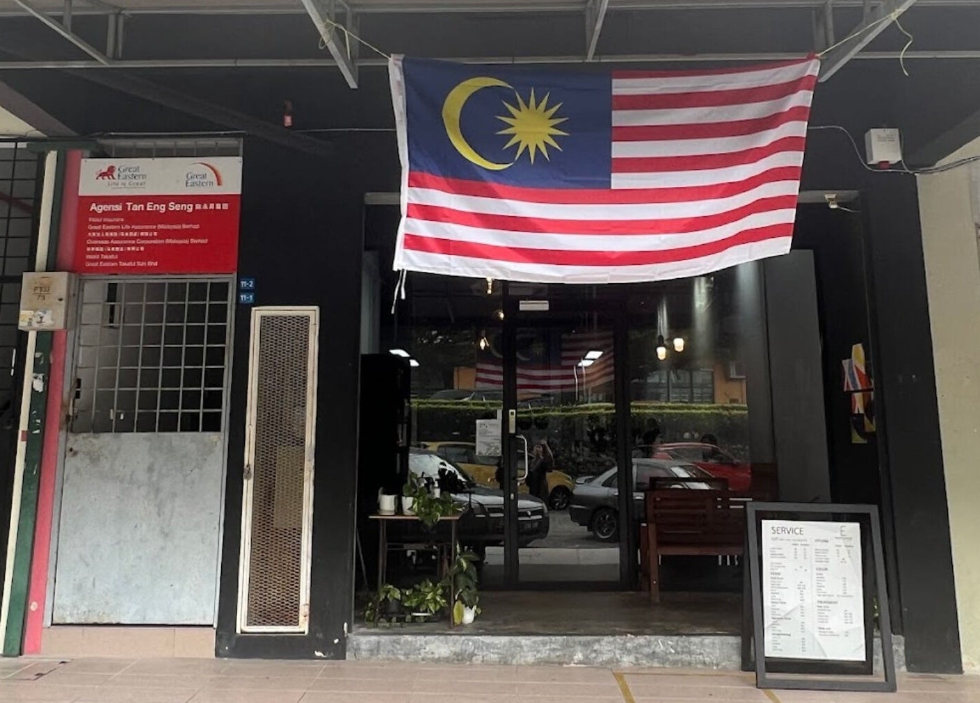 Entrance of Elements Hair Salon in Cheras, Selangor, MY, featuring potted plants and Malaysia flag.