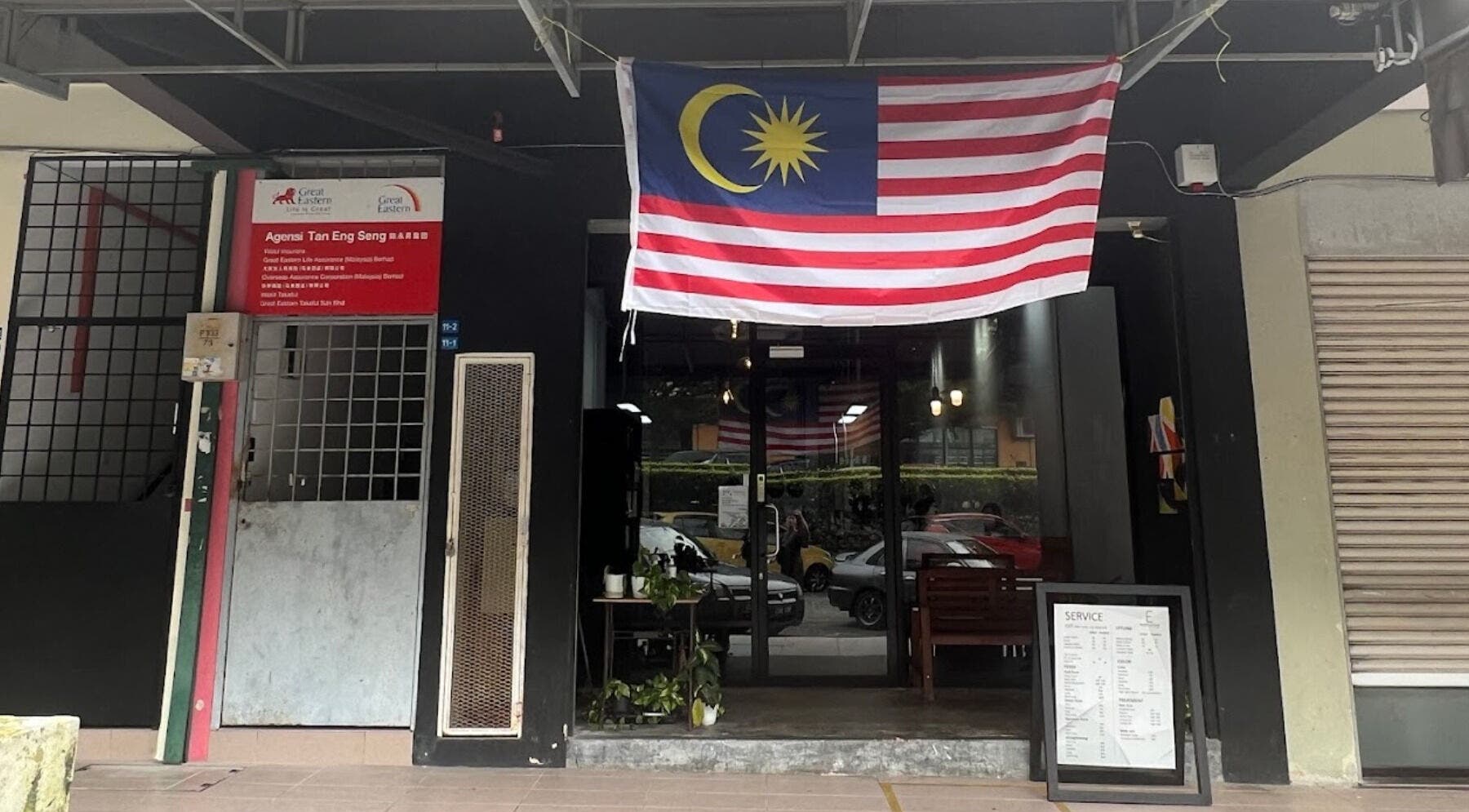 Entrance of Elements Hair Salon in Cheras, Selangor, MY, featuring potted plants and Malaysia flag.