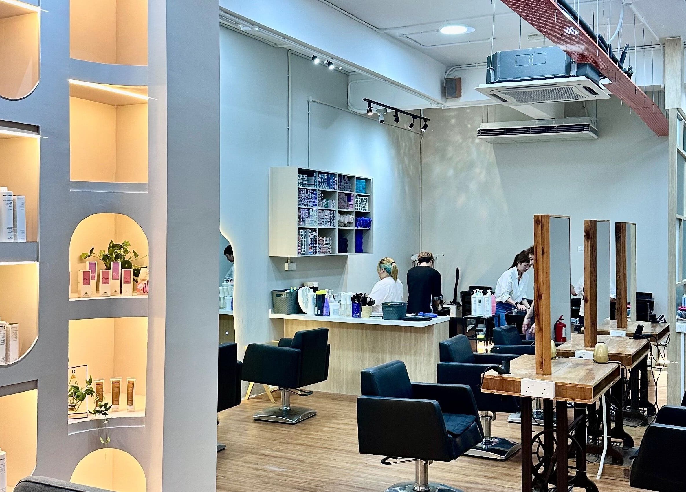 Elements Hair Salon in Cheras, Selangor, MY showcases a modern interior with stylish chairs and lit product shelves.