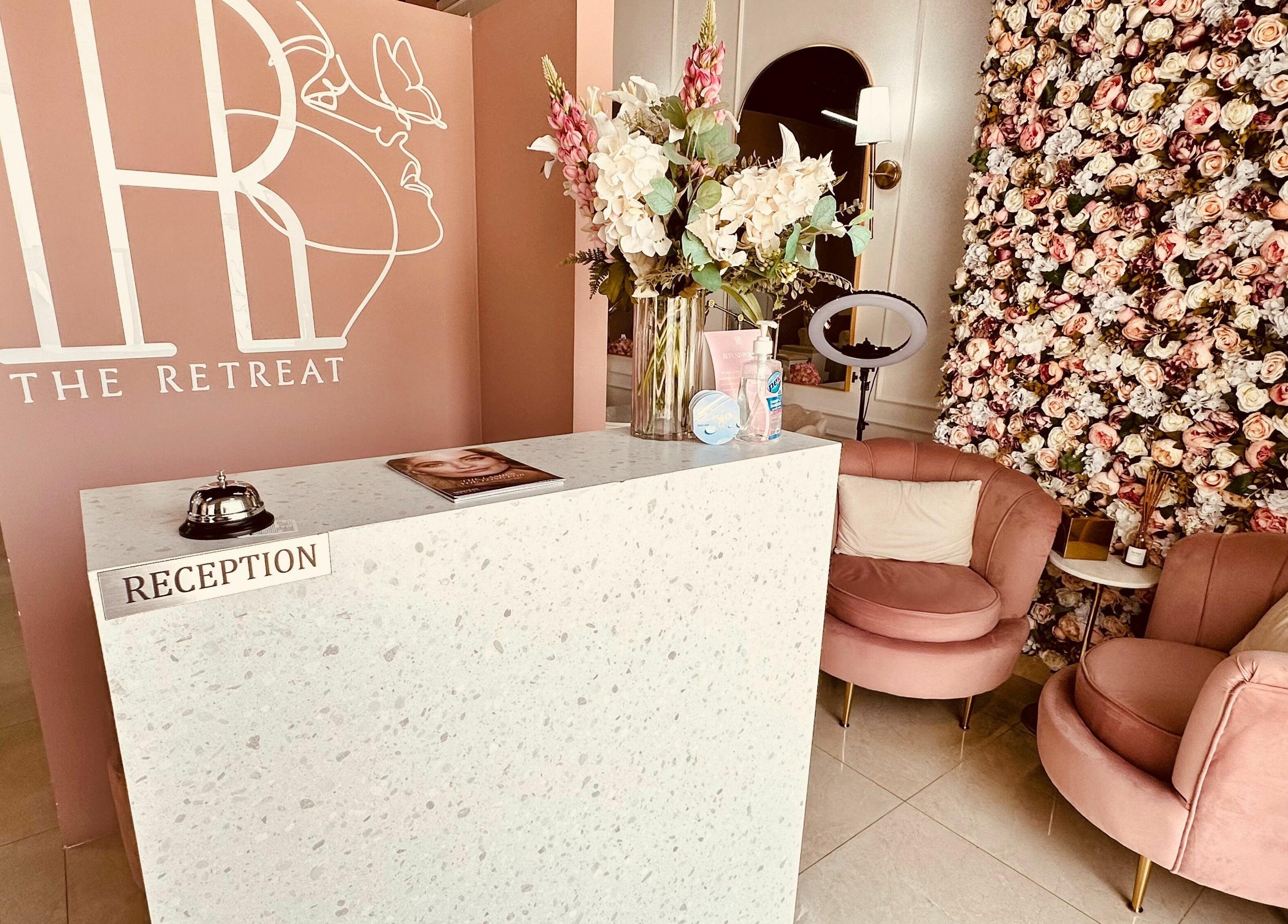 Reception area at The Retreat, Dubai, Dubai, AE with stylish decor and floral accents.