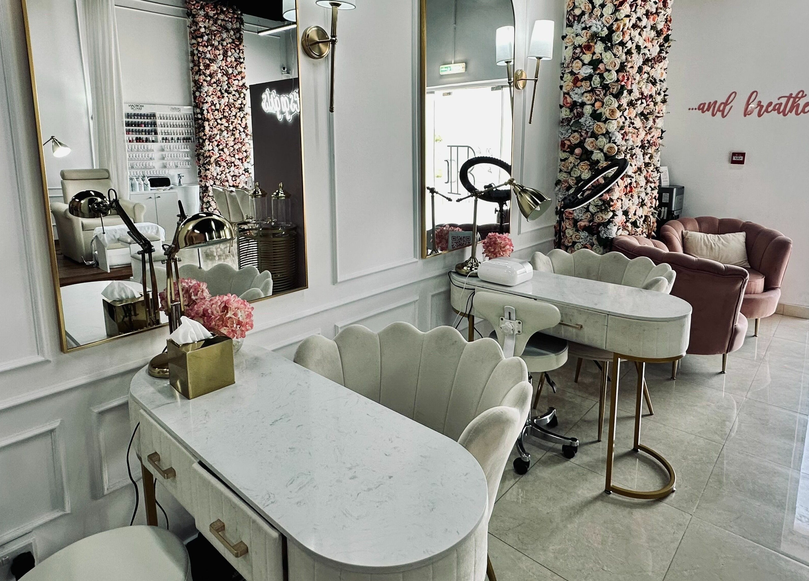 Chic salon interior at The Retreat in Dubai, Dubai, AE with plush seating and floral decor.