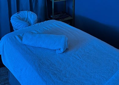 Luxurious massage bed in a tranquil blue room at Thyme & Calm, Kangaroo Point, Queensland, AU.