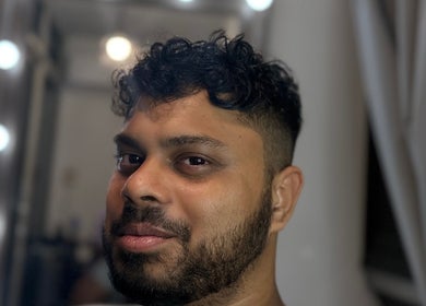 Client with fresh hairstyle at Effcutz, Singapore, SG, glowing under soft salon lighting.
