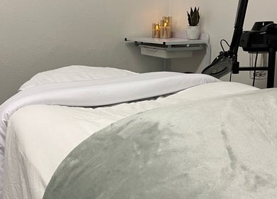 Cozy massage bed at Bridget Wilson Esthetics Studio in Sault Ste. Marie, Ontario, CA, inviting relaxation.