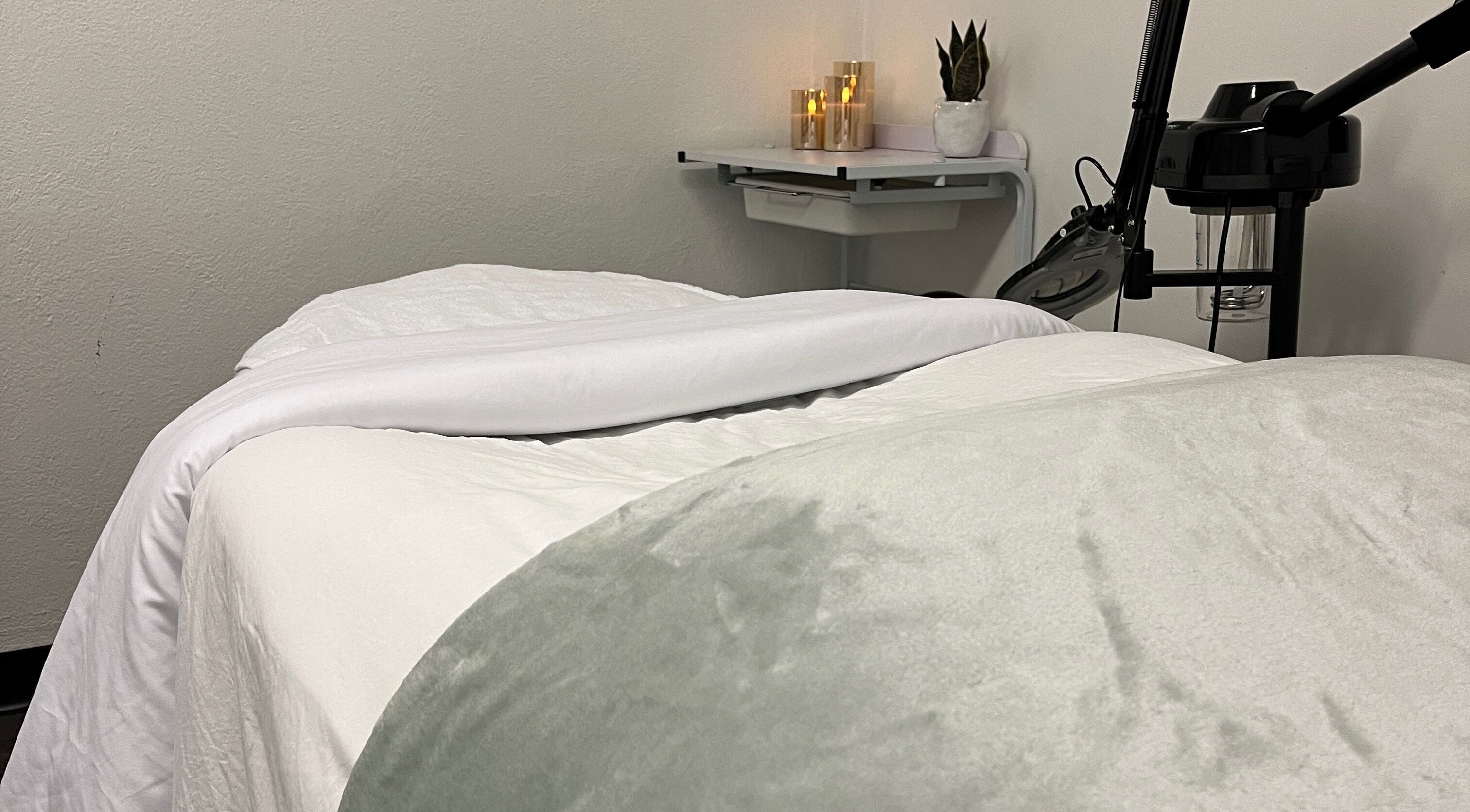 Cozy massage bed at Bridget Wilson Esthetics Studio in Sault Ste. Marie, Ontario, CA, inviting relaxation.