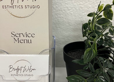 Bridget Wilson Esthetics Studio service menu in Sault Ste. Marie, Ontario, CA, with potted plant.